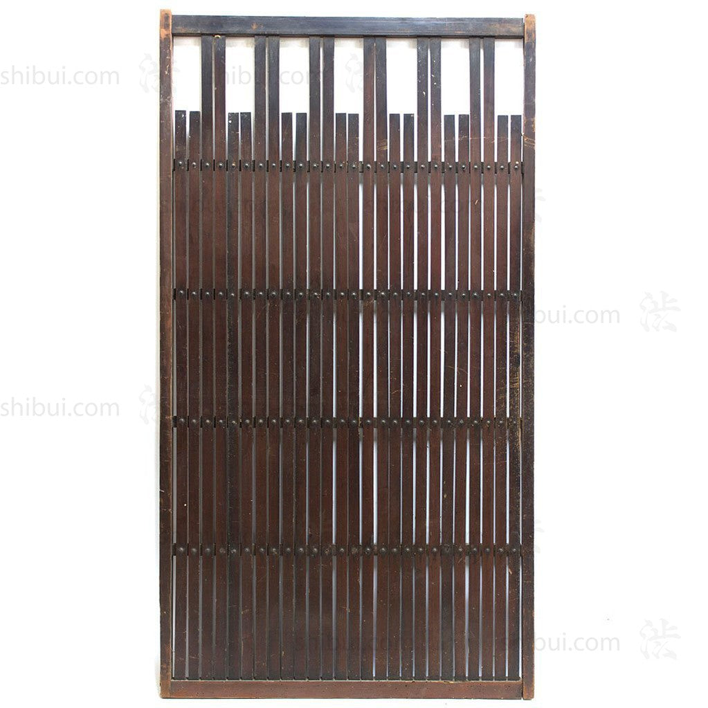 wooden door with thin slats and rivets