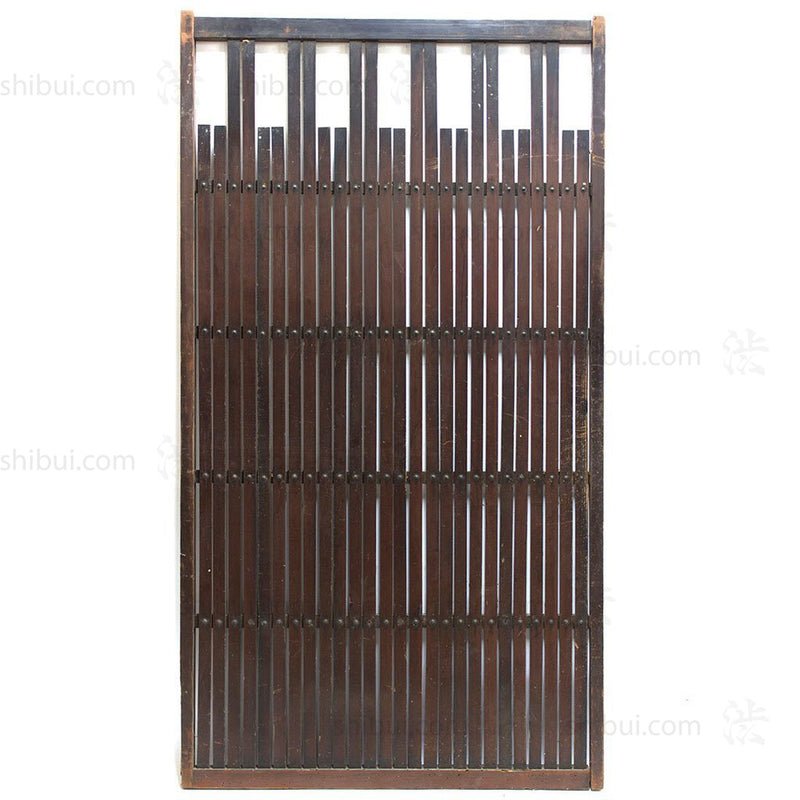 wooden door with thin slats and rivets