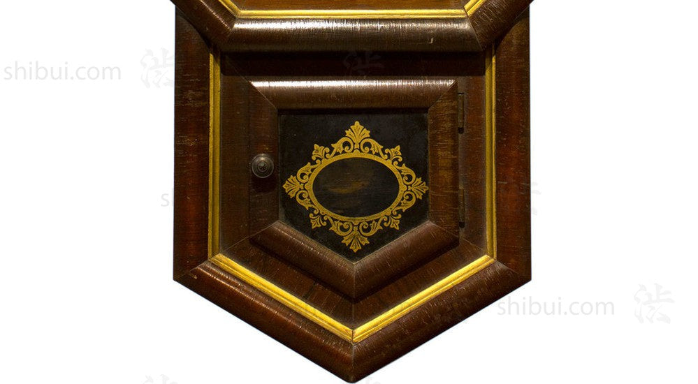 closeup of pendulum stored behind glass door