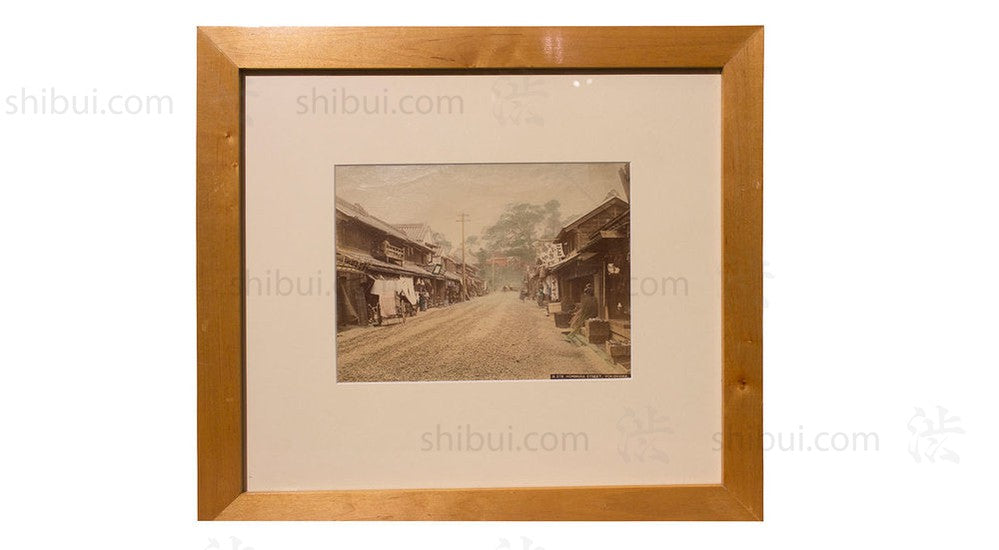 framed photograph of dirt road and village