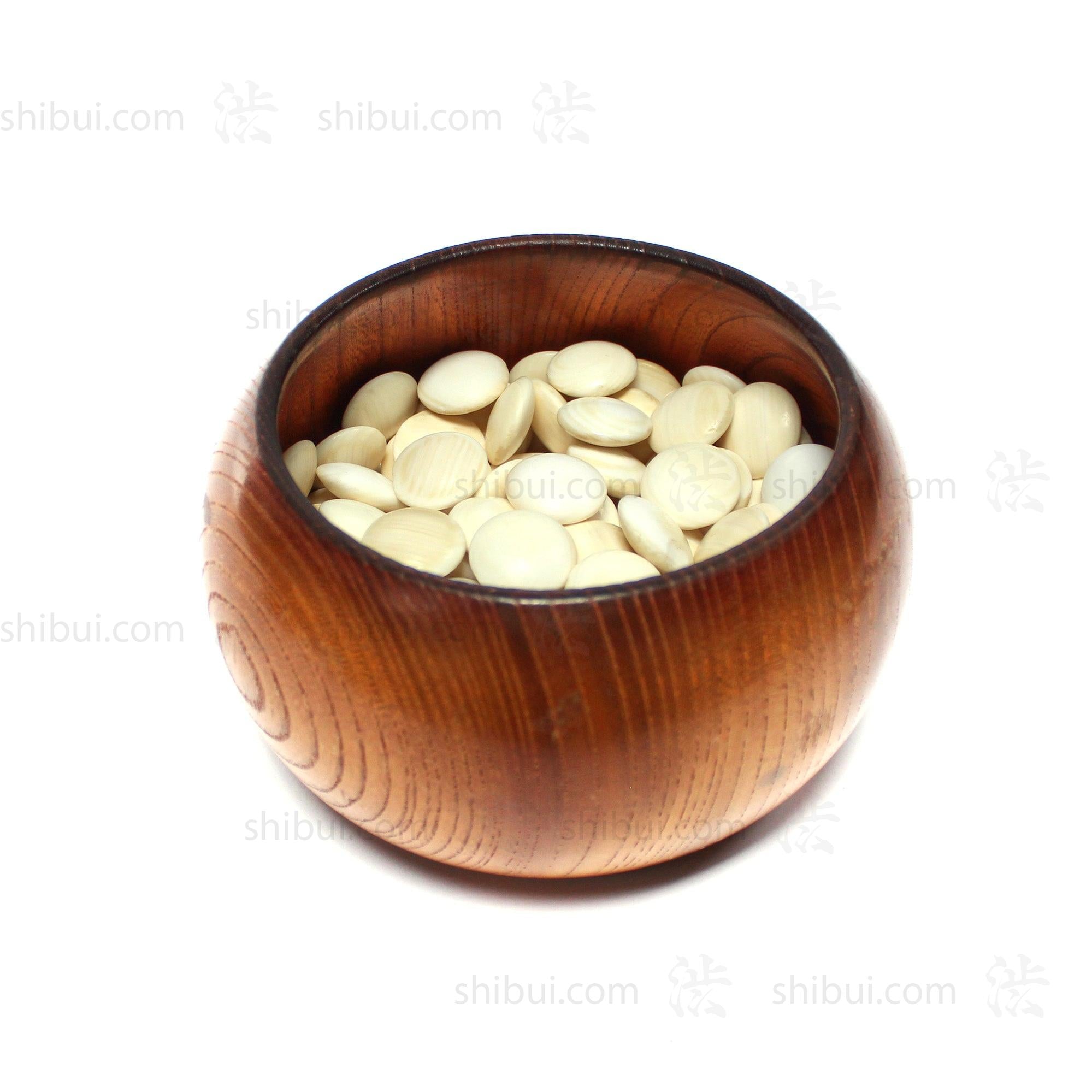 Open go seigen goke (rounded chinese-style go stone bowl) containing 157 clamshell (white) goishi (go stones).