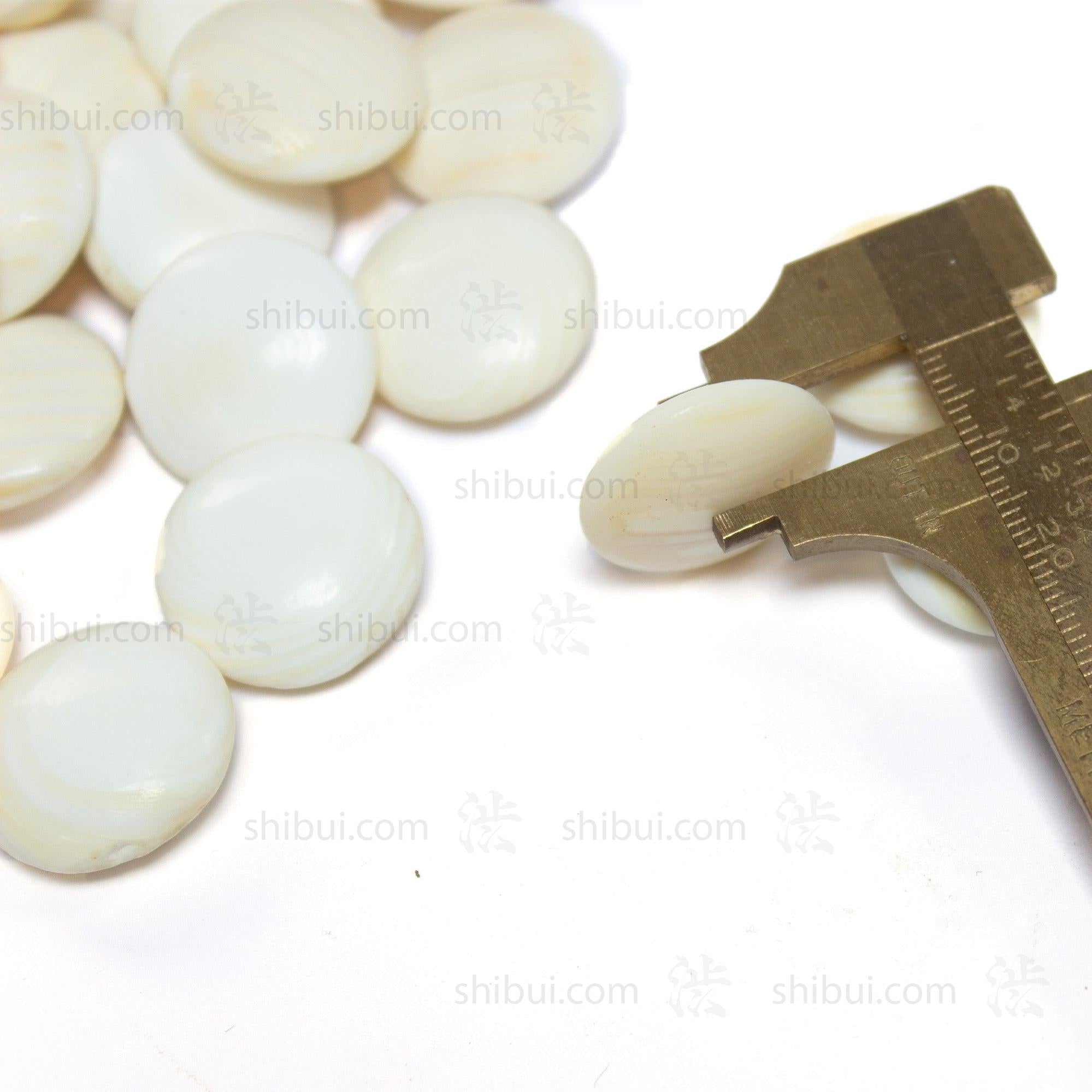 Clamshell goishi (go stones) with a minor axis of just under three eighths of an inch.