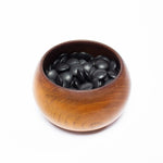 Open go seigen goke (rounded chinese-style go stone bowl) containing 175 river slate (black) goishi (go stones).