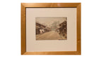 framed photograph of dirt road and village